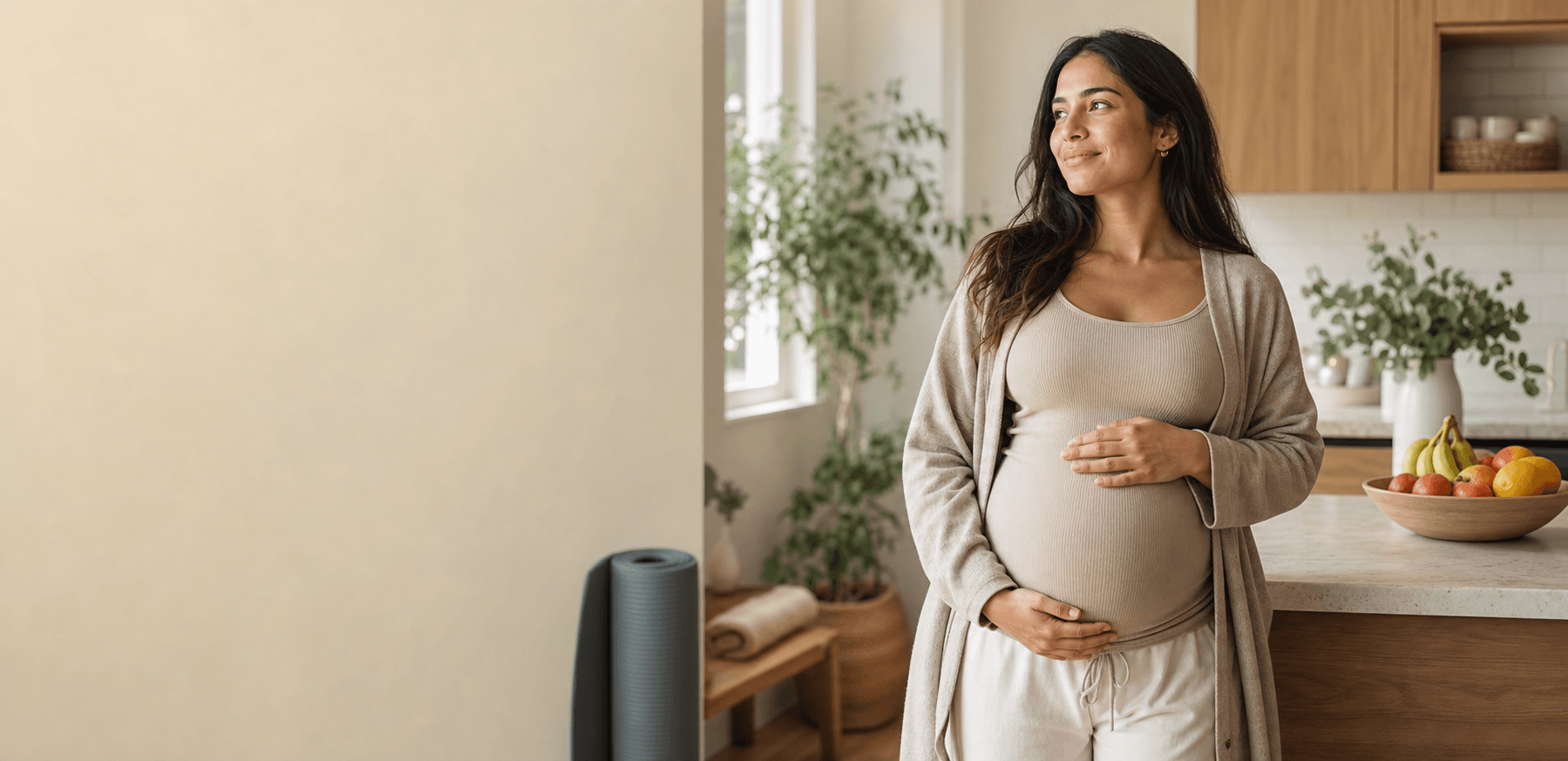 Expectant mother in a calm home setting with fruit and a yoga mat for pregnancy nutrition and movement guidance